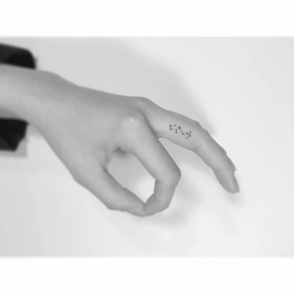 Scorpius constellation tattooed on the finger, minimalistic style.