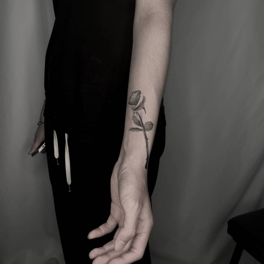 Rose tattoo in blackwork style located on the wrist.