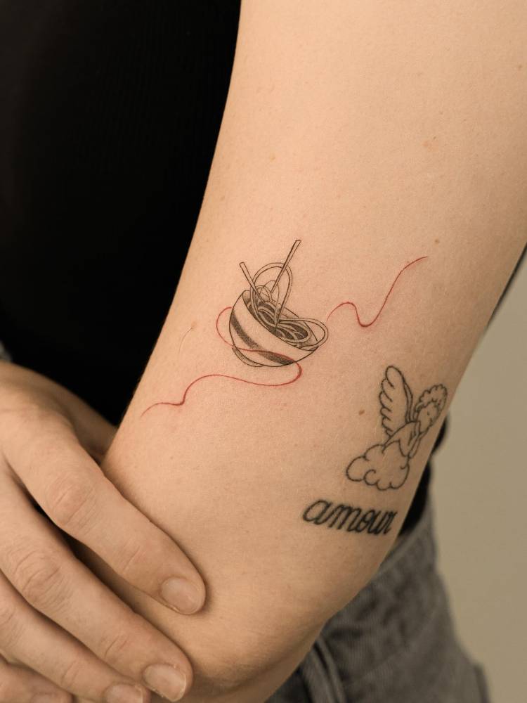 Ramen tattoo in illustrative style located on the upper arm.