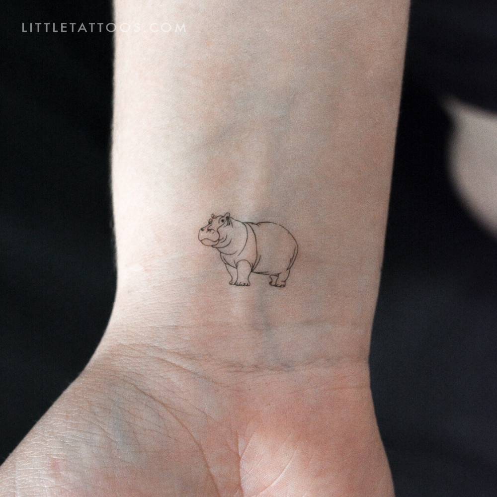 Fine line style hippopotamus temporary tattoo located on the wrist.
