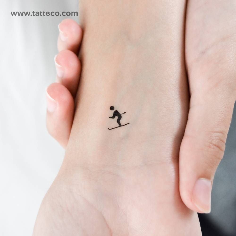 Tiny minimalistic skier temporary tattoo located on the wrist.
