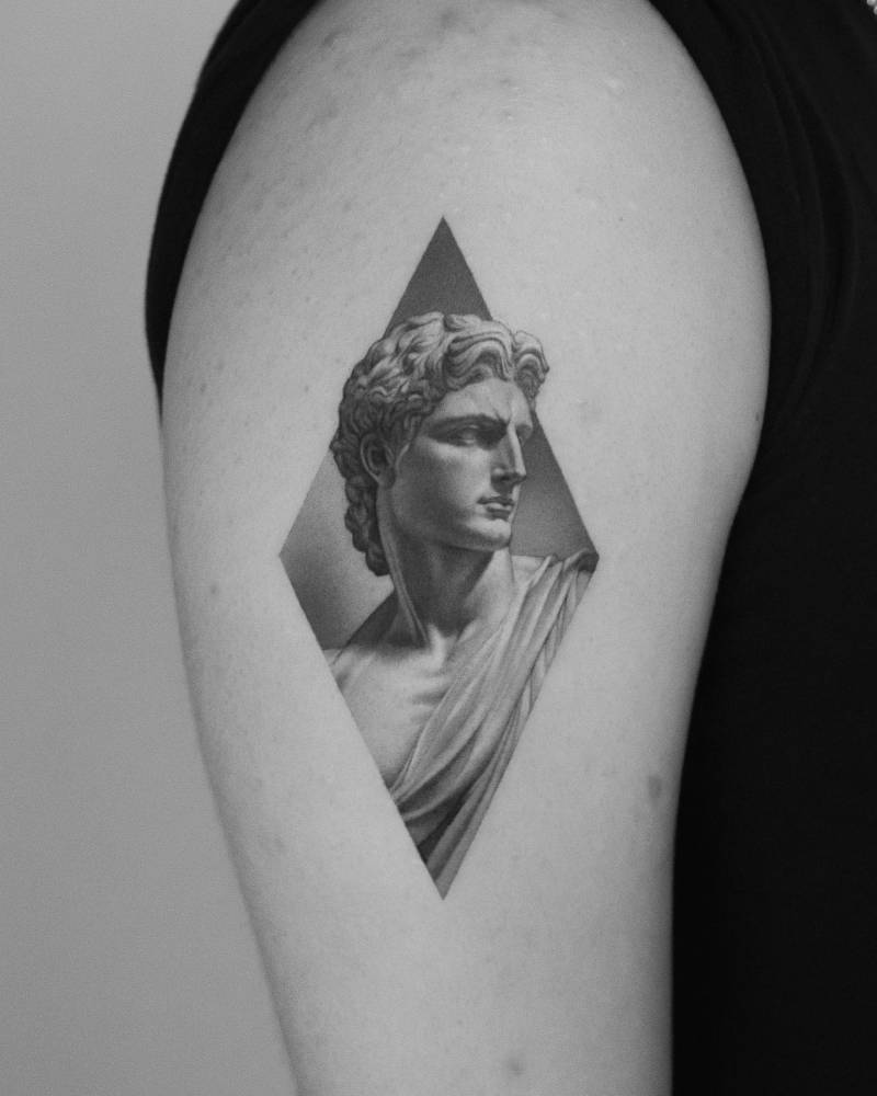 Apollo tattoo in micro-realistic style done on the upper arm.