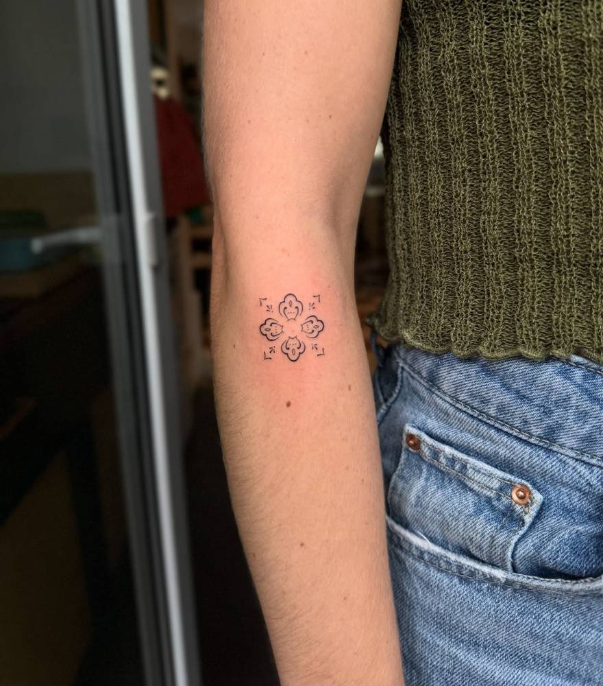 Ornamental design tattooed on the forearm.