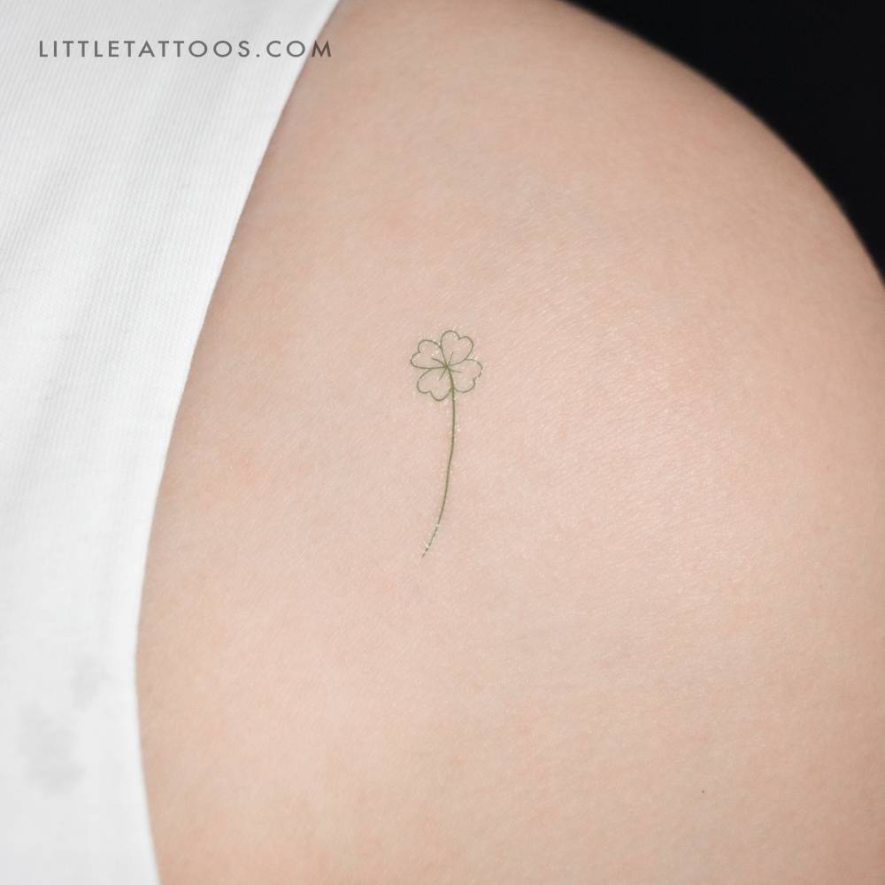 Green four-leaf clover temporary tattoo located on the shoulder.