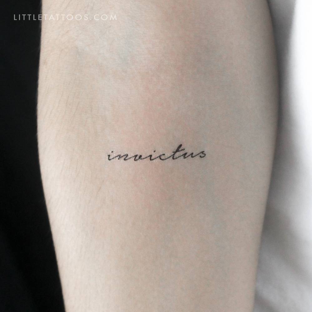 Handwritten font word "invictus" temporary tattoo located on the inner forearm.