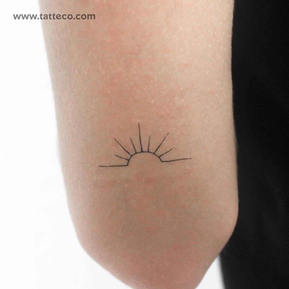 Minimal sunset temporary tattoo located on the tricep.