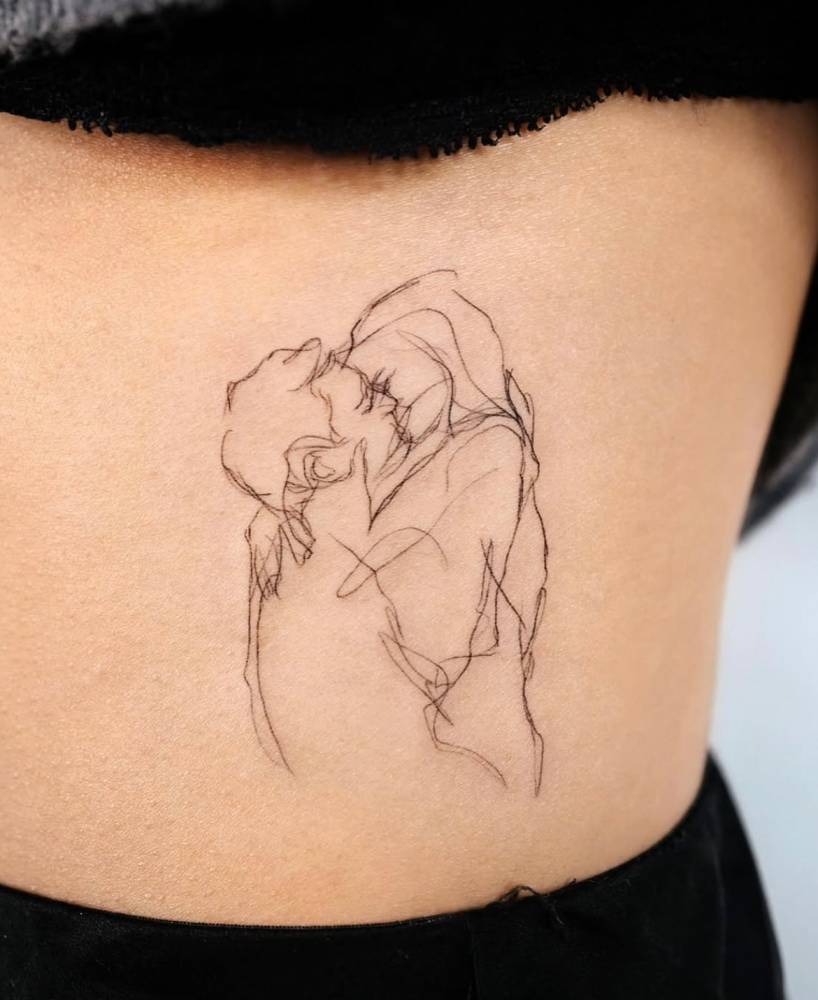 Sketch work style kiss tattoo placed on the waist.