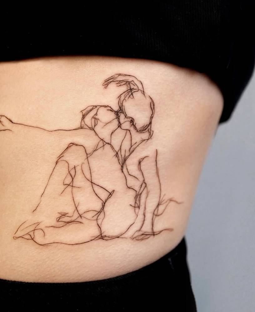 Kiss tattoo done on the waist, sketch work style.