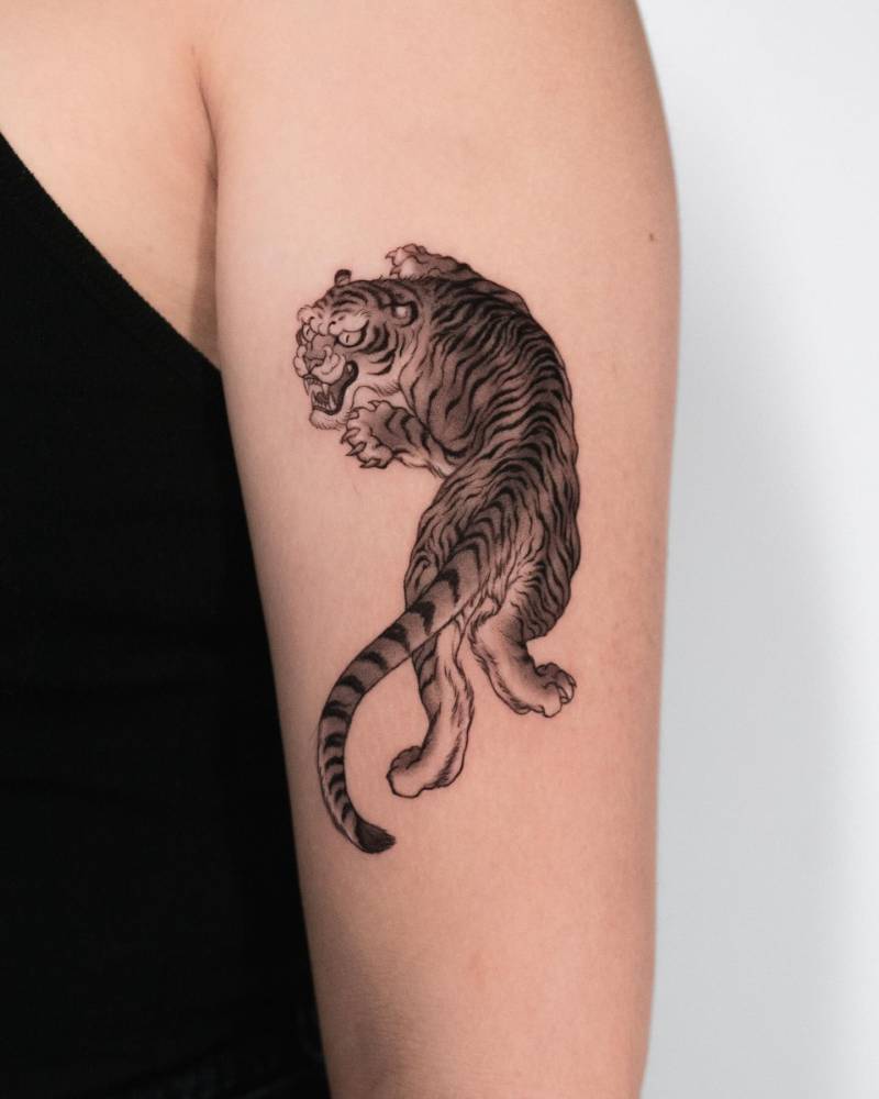 Oriental style tiger tattoo placed on the upper arm.