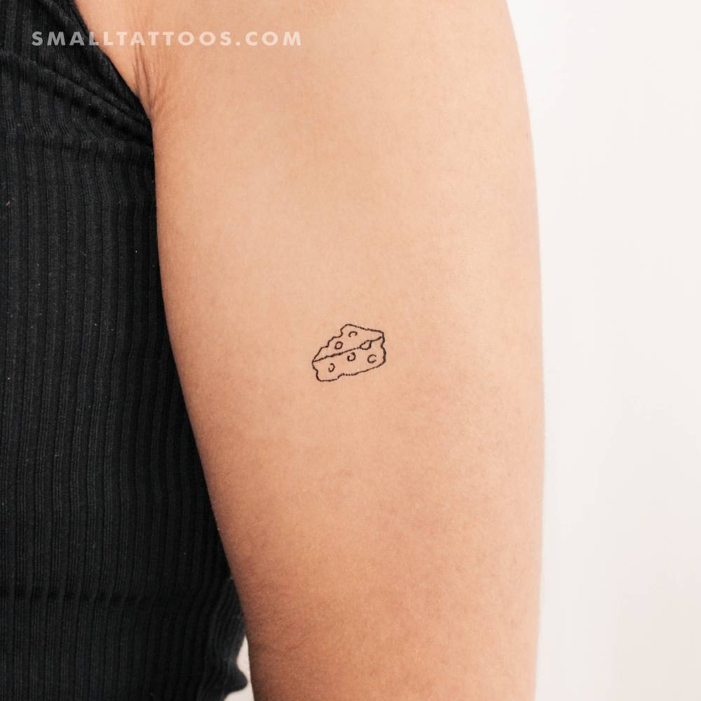 Minimalist cheese temporary tattoo located on the upper arm.