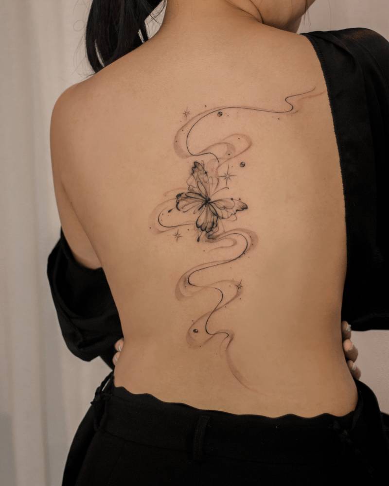 Butterfly flow tattoo in illustrative style located on the back.