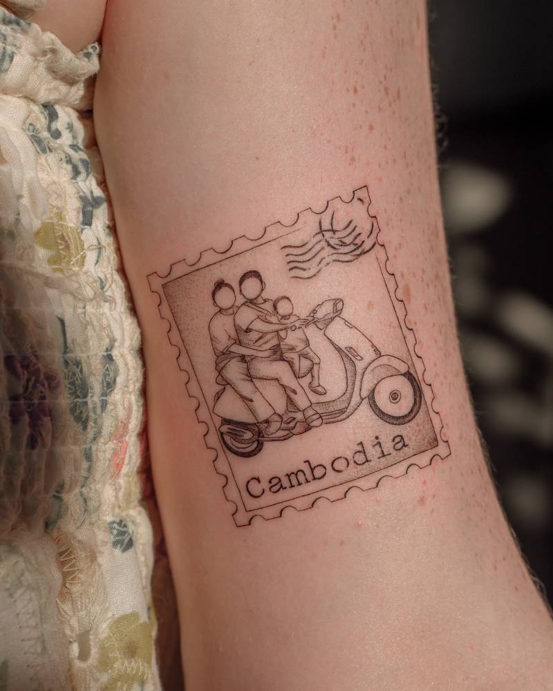Family stamp tattooed on the bicep, illustrative style.