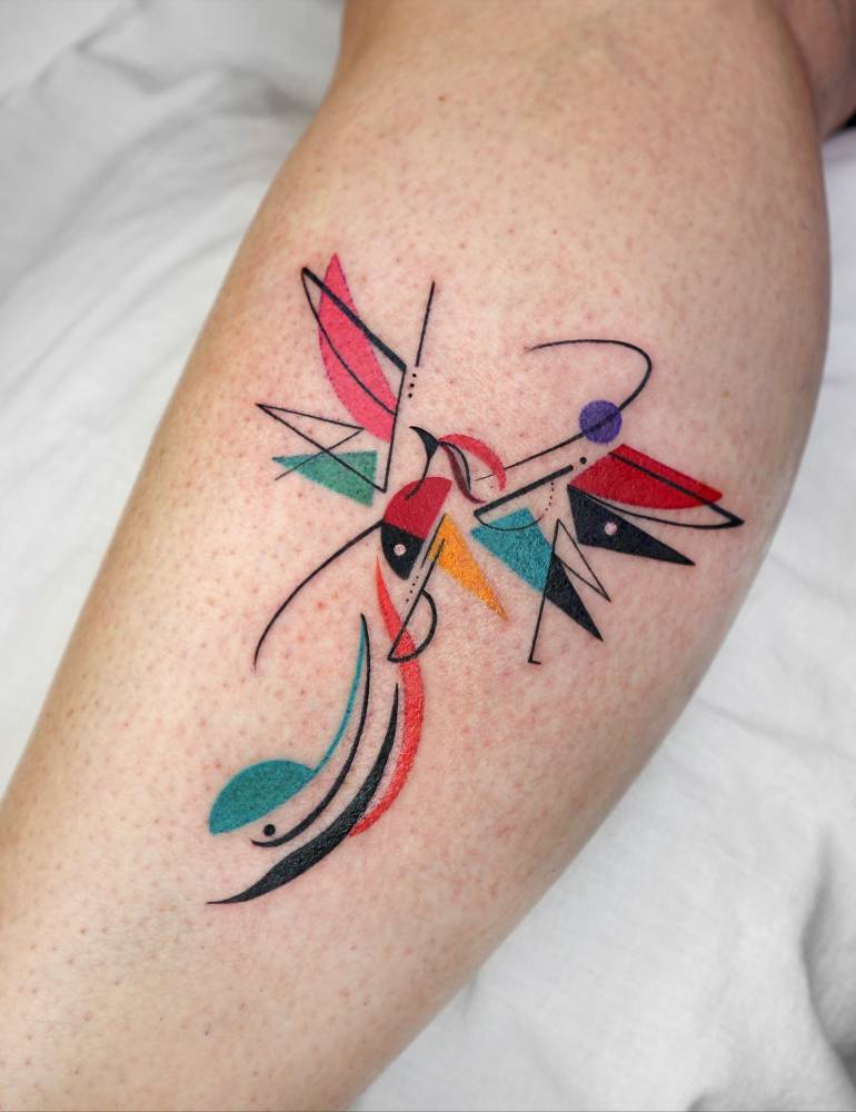Abstract style phoenix tattoo located on the calf.