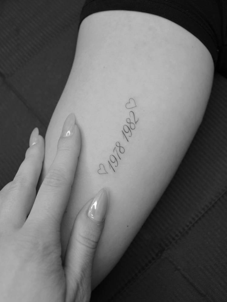 "1978" and "1982" tattooed on the inner arm.