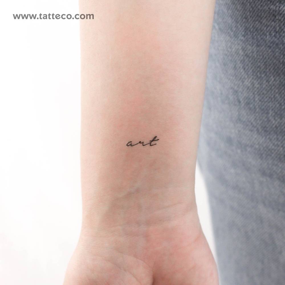 Handwritten font word "art" temporary tattoo located on the wrist.