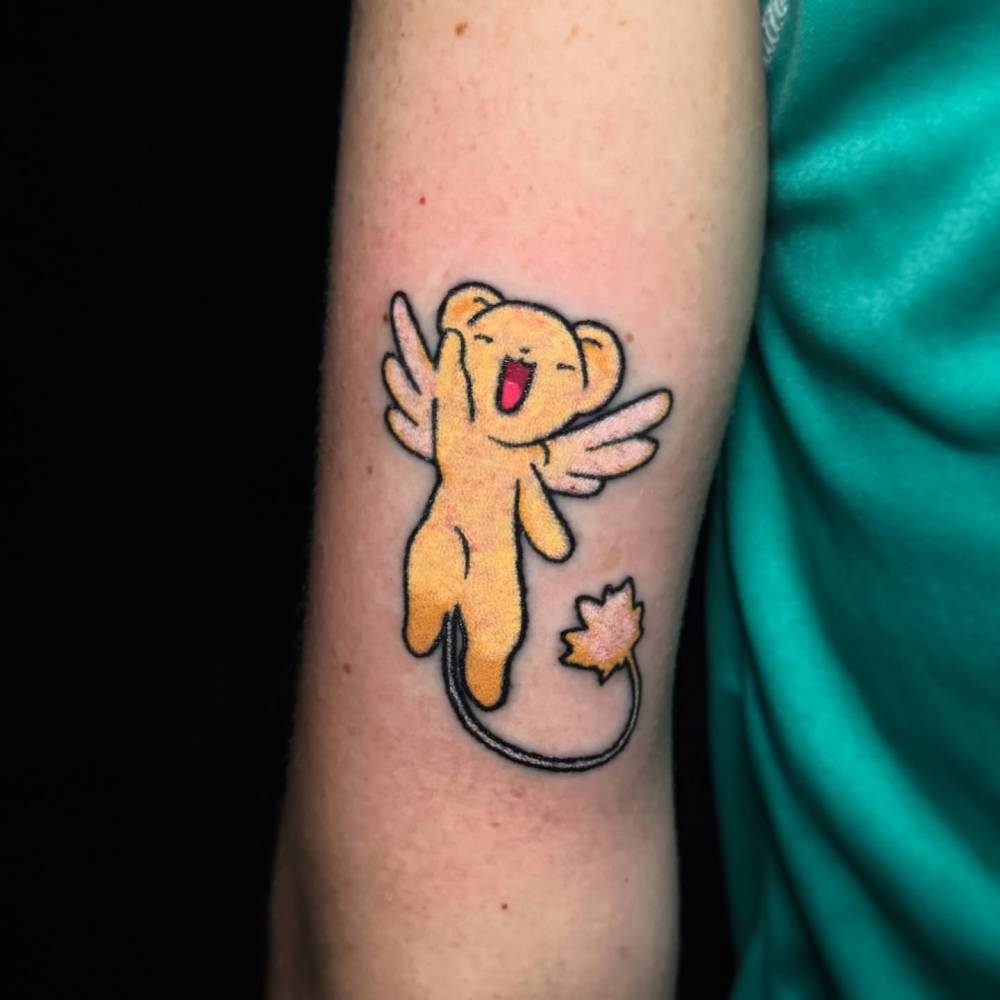 Cerberus from Cardcaptors Sakura tattooed on the tricep.