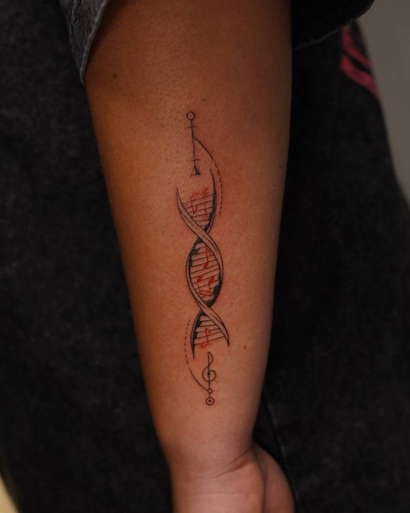 DNA tattoo in illustrative style located on the forearm.