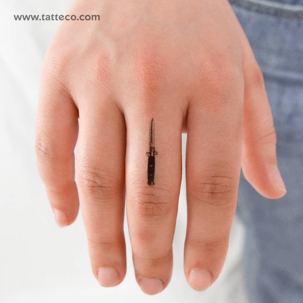 Stiletto automatic knife temporary tattoo located on the finger.