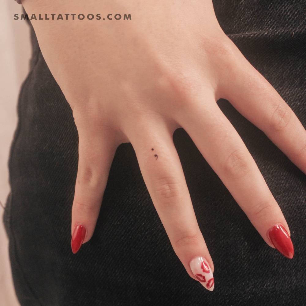 Tiny minimalistic semicolon temporary tattoo located on the finger.