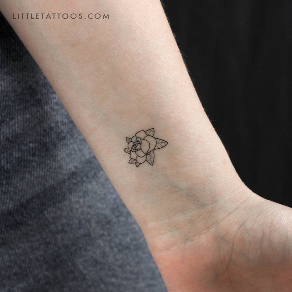 Fine line rose head temporary tattoo located on the wrist.
