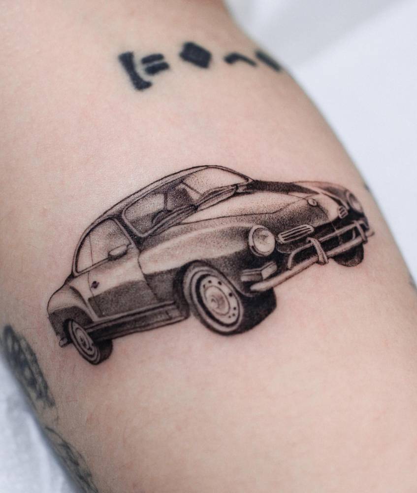 Karmann Ghia tattoo located on the forearm, illustrative style.