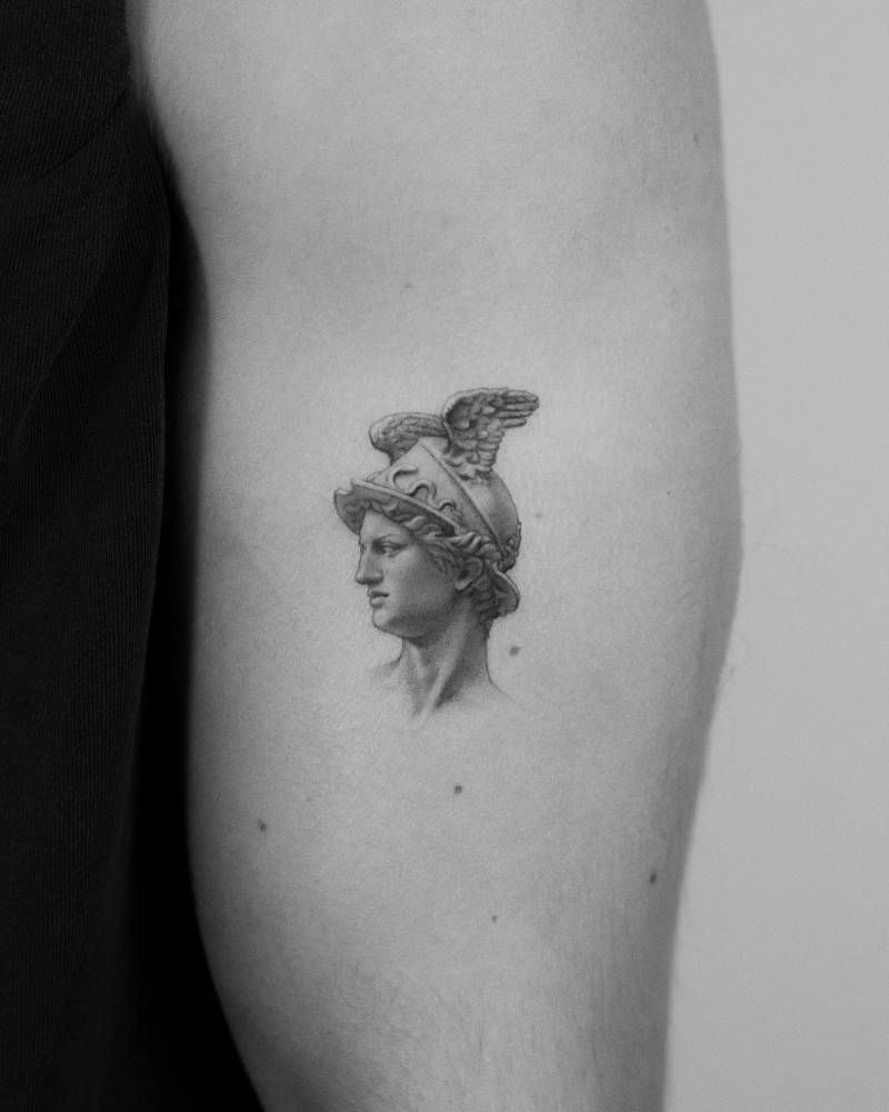 Hermes portrait tattoo located on the upper arm, done in micro-realism.