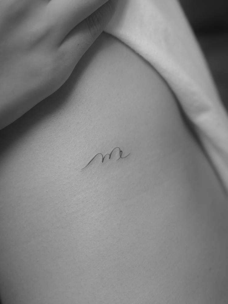 Scorpio zodiac symbol tattoo in minimalistic style.