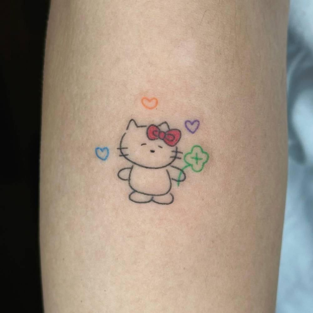 Hello Kitty tattoo in minimalistic style located on the forearm.