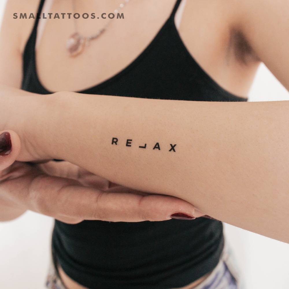 Word "relax" temporary tattoo located on the wrist.