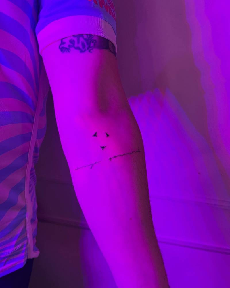 Minimalistic flying birds tattoo located on the inner forearm.
