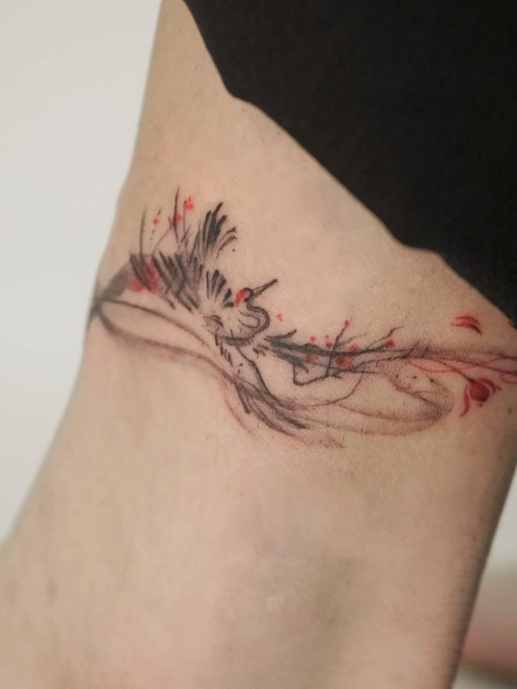 Red crowned crane tattoo located on the bicep.