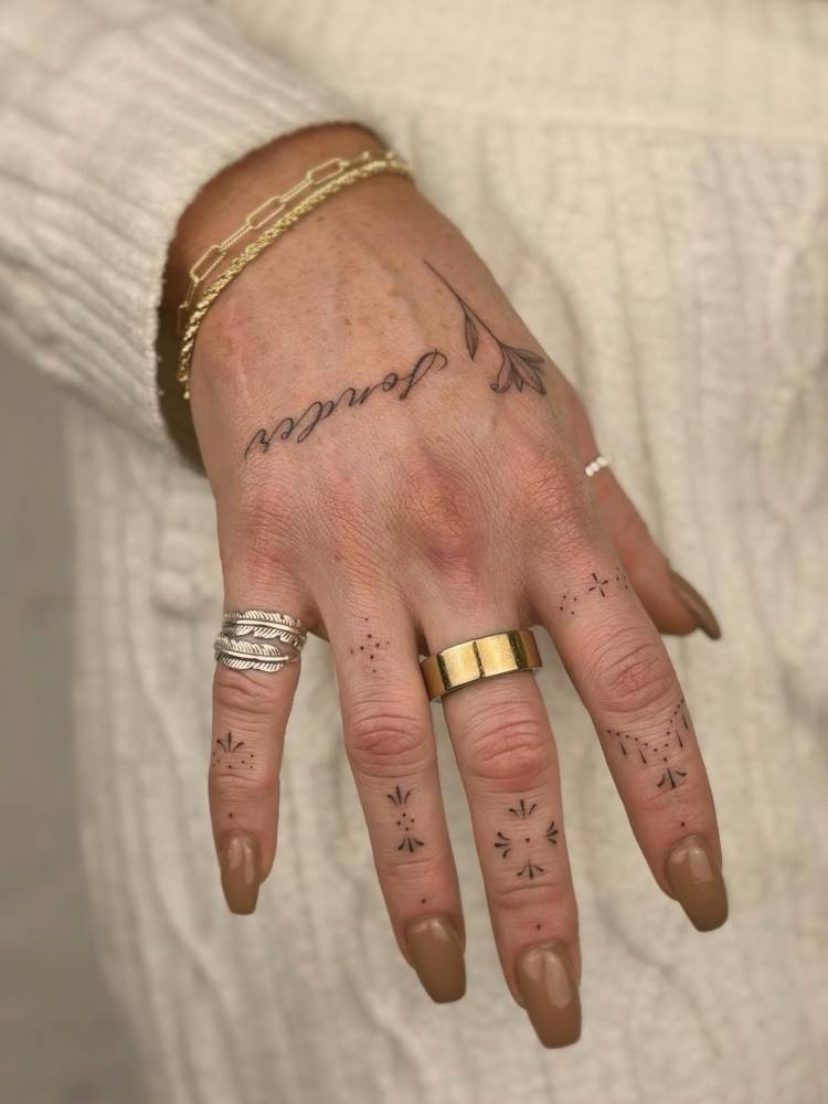 Ornamental finger composition tattoos.