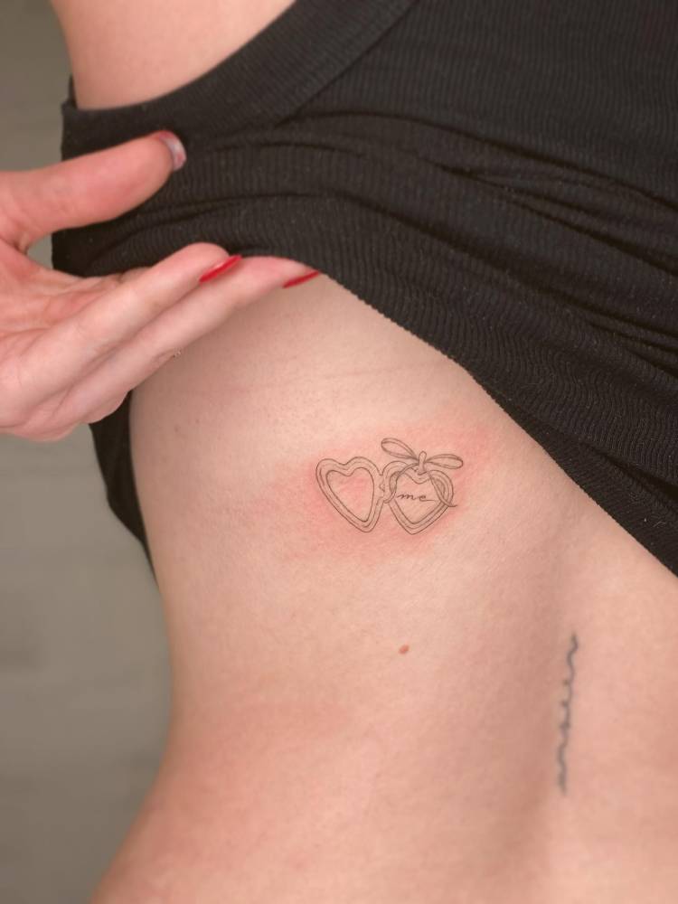 Heart pendant with the word "me" located on the back.