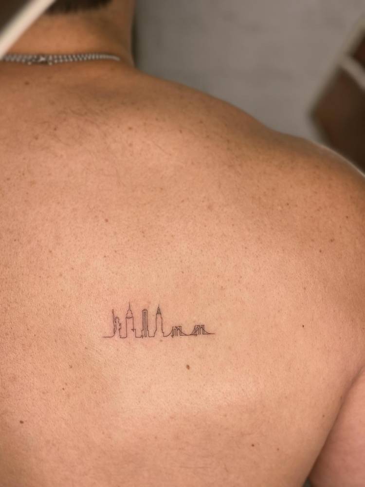 New York City skyline tattoo located on the shoulder blade.