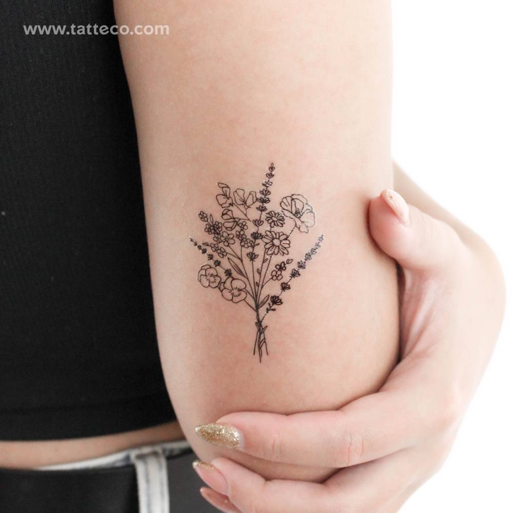 Bouquet temporary tattoo in fine line style located on the tricep.