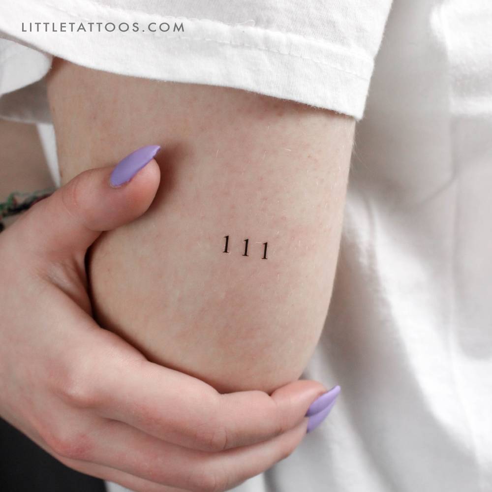 Little "111" angel number temporary tattoo located on the tricep.