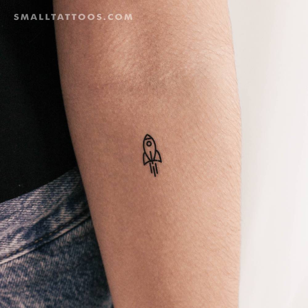 Minimalist rocket temporary tattoo placed on the inner forearm.