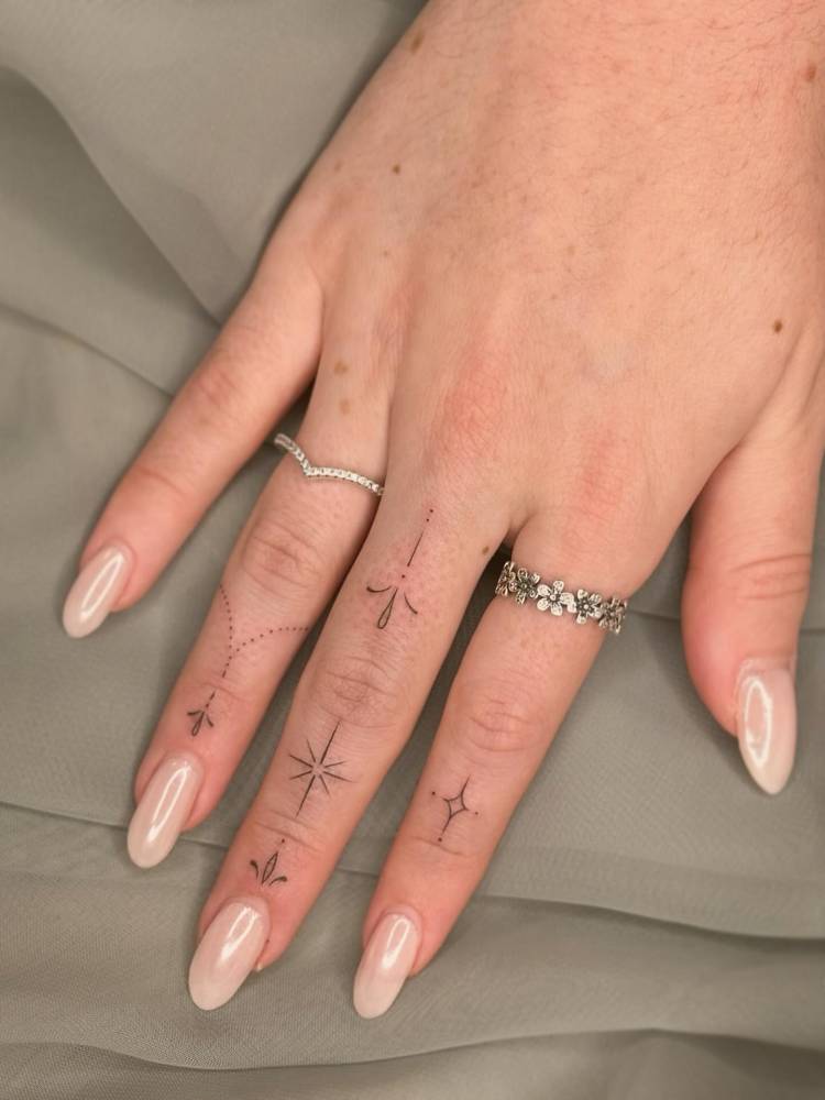 Fine line style ornamental finger composition tattoos.