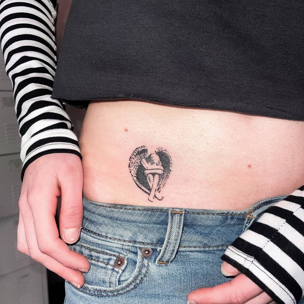 Crying angel tattoo in illustrative style located on the hip.