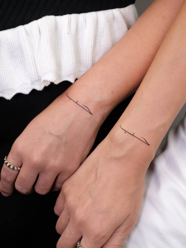 Matching "love" in Arabic tattoo for best friends.