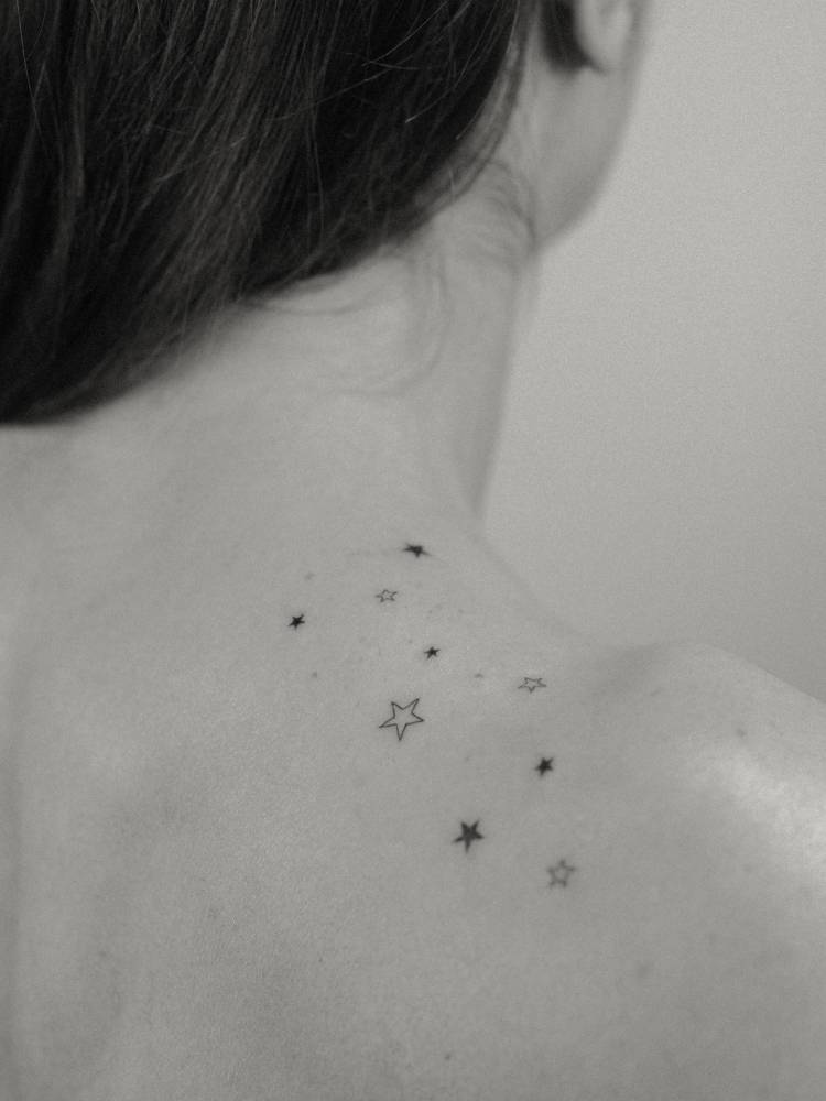 Minimalistic style stars tattoo located on the top of shoulder.