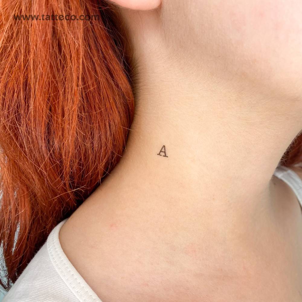 "A" uppercase typewriter letter temporary tattoo located on the neck.