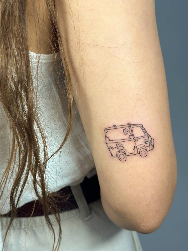 Van tattoo in fine line style located on the tricep.