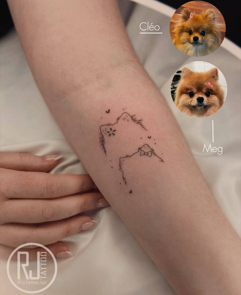 Pomeranian ears tattooed on the inner forearm, fine line style.