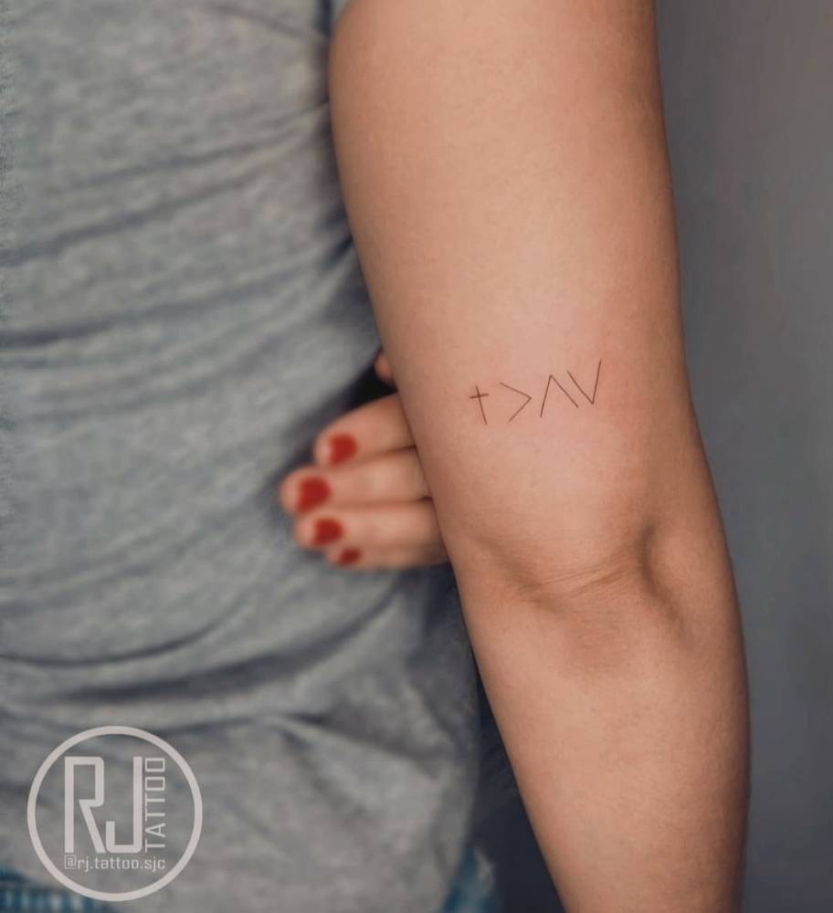 God is greater than my highs and lows symbol tattooed on the tricep.