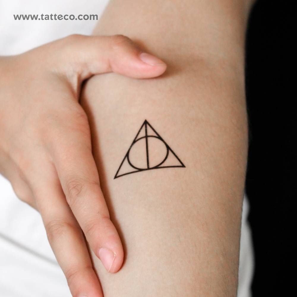 Deathly Hallows symbol semi-permanent tattoo located on the inner forearm.