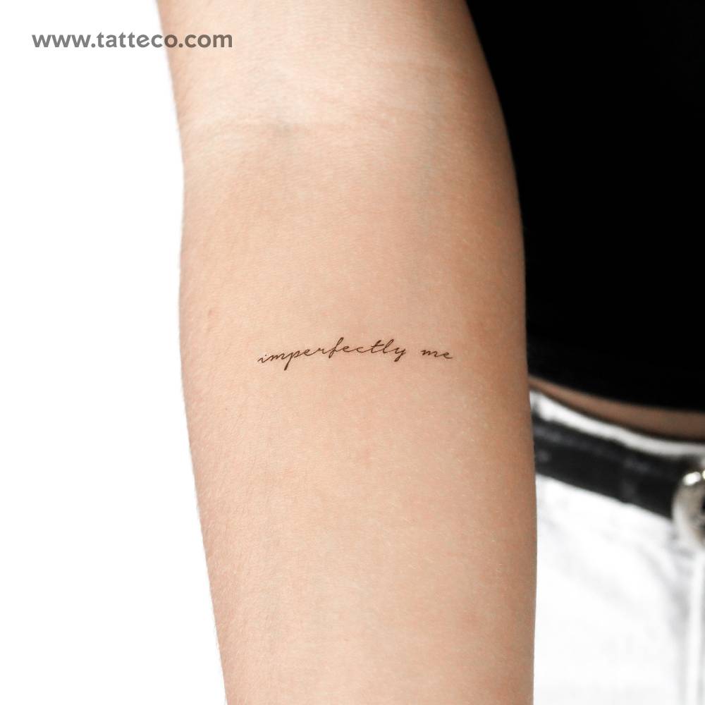 Handwritten font "imperfectly me" temporary tattoo located on the inner forearm.