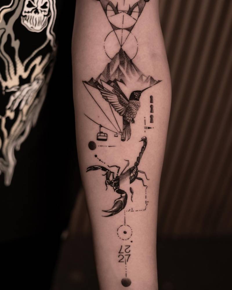 Hummingbird and scorpion tattoo located on the inner forearm.