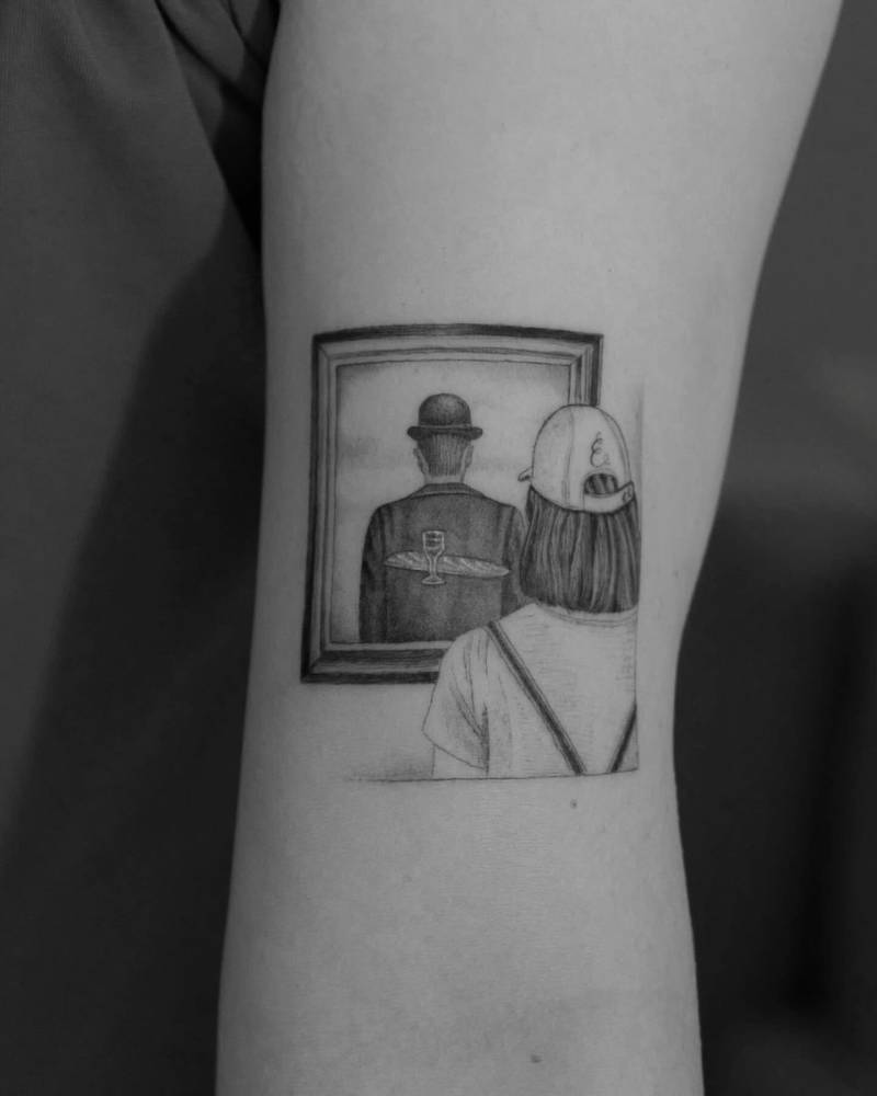 Tattoo of his wife looking at Magritte's 'The Intimate Friend'.