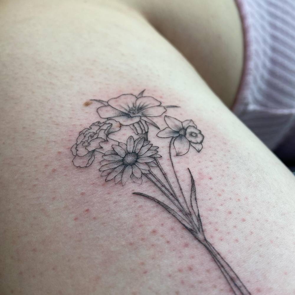 Delicate flower bouquet tattoo done in fine line.